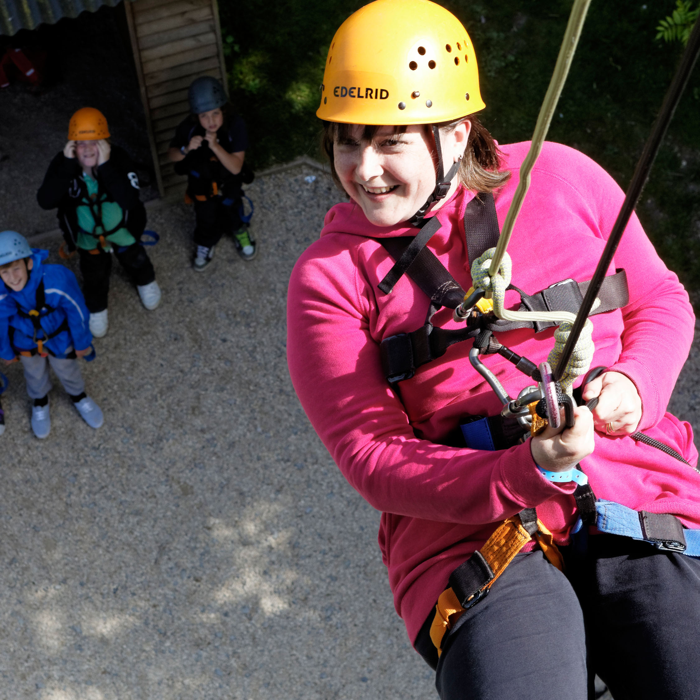 Teacher on an abseil tower at PGL